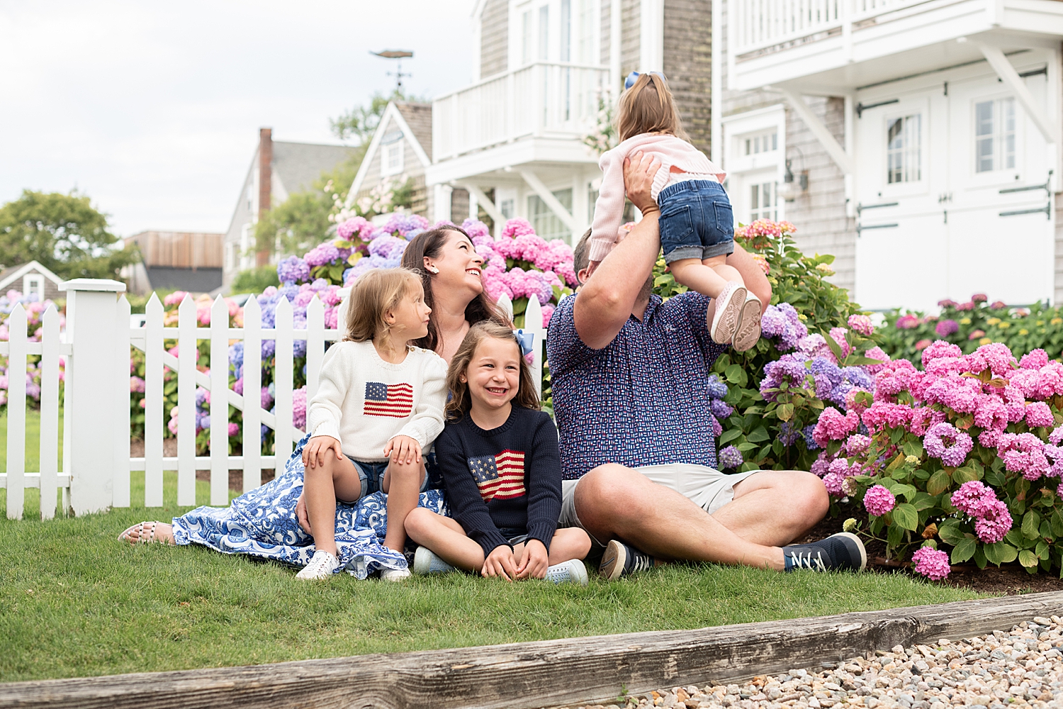 family of five sits on grass after learning top locations in Nantucket for your family photo session