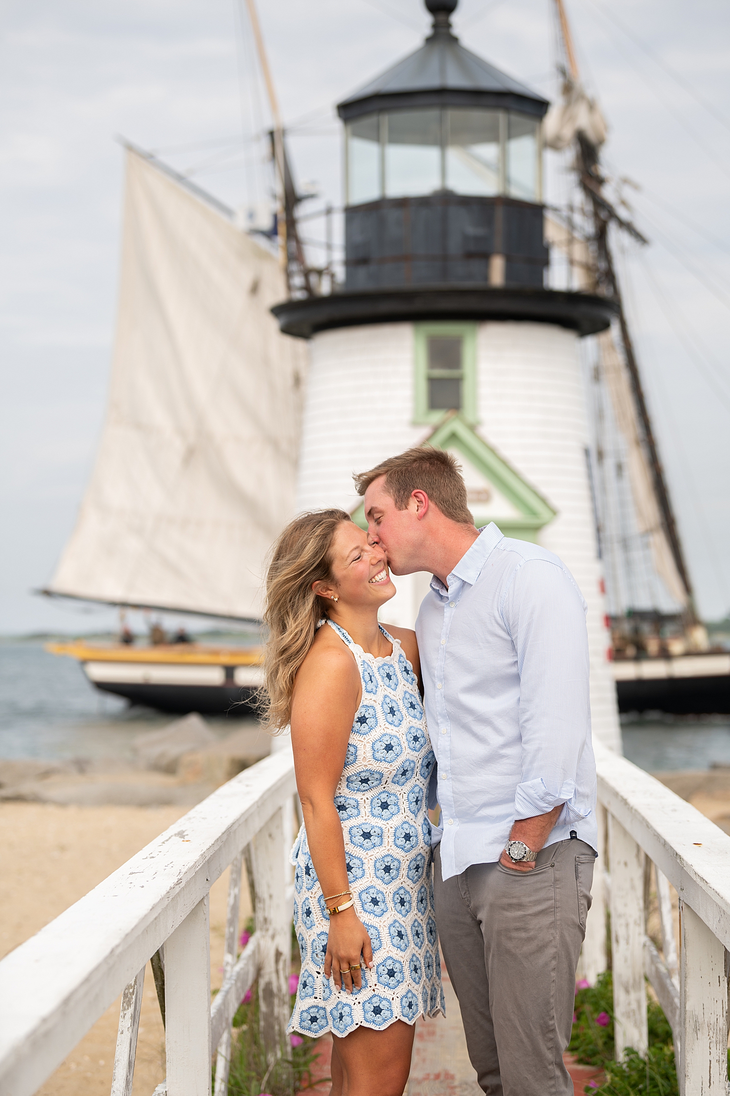 groom-to-be leans in to kiss fiance on the cheek by Nantucket family photographer