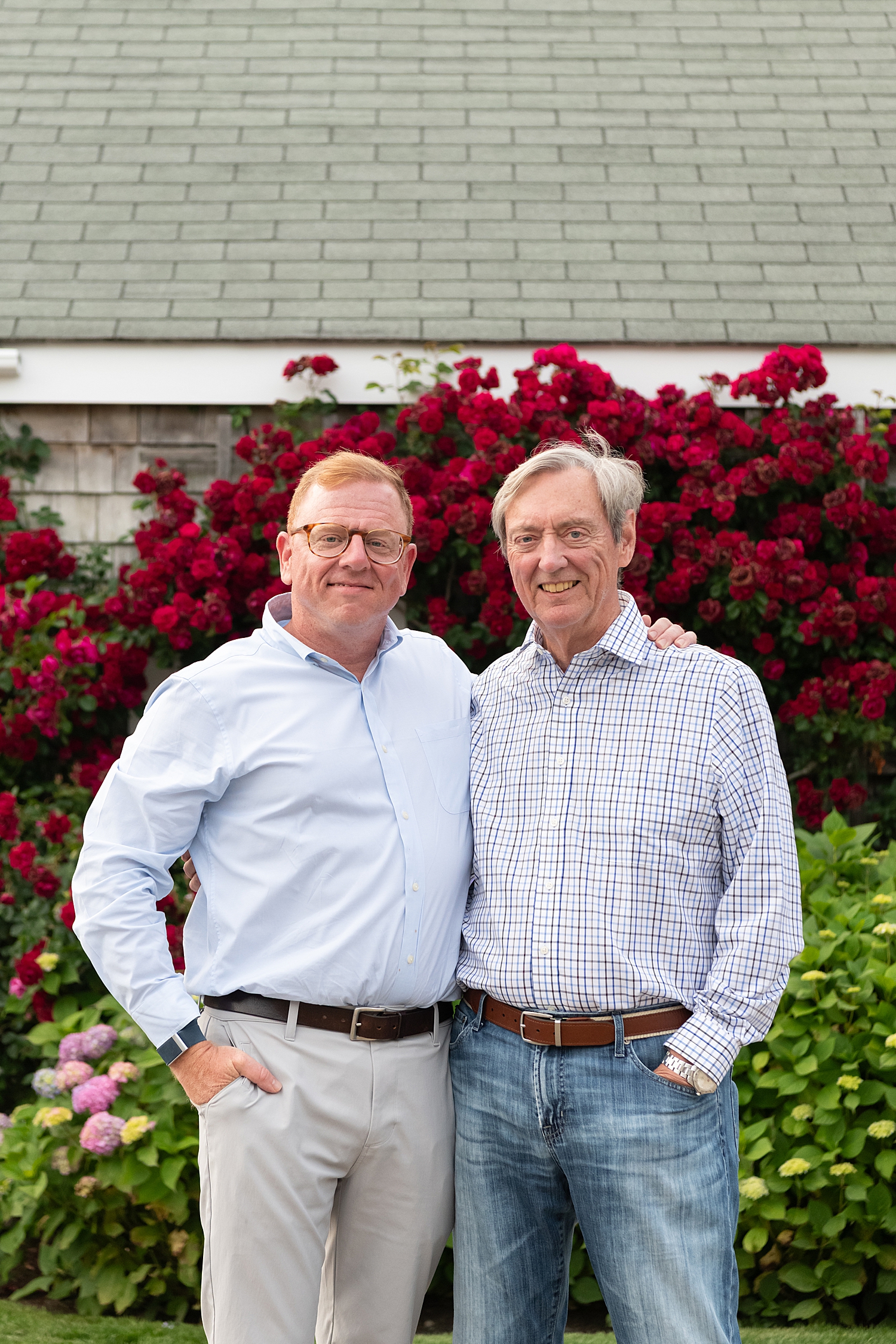 adult father and son with rose flowers behind them by Rachel Elizabeth Photography