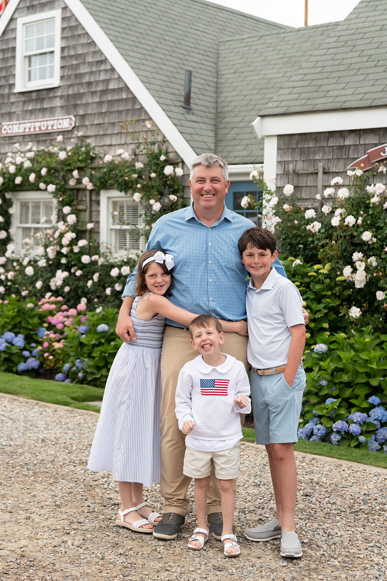 man with his three kids on old new england road by Rachel Elizabeth Photography