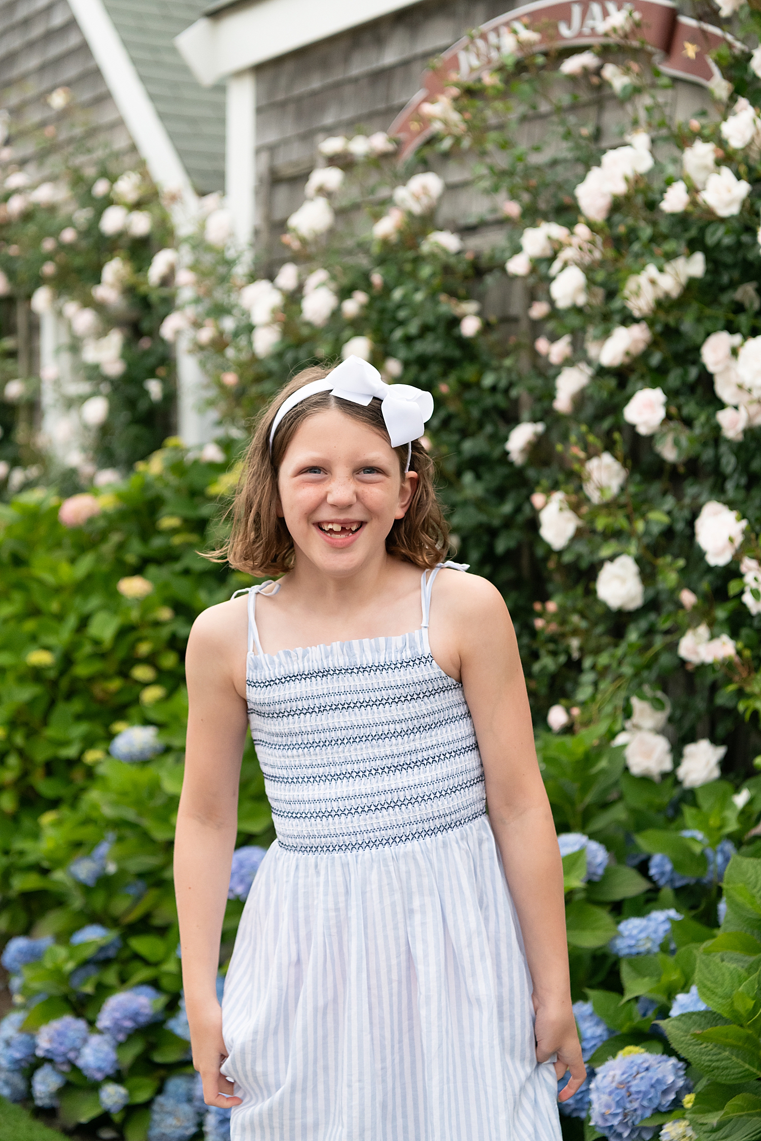 girl in blue dress with bow in her hair at Old North Wharf