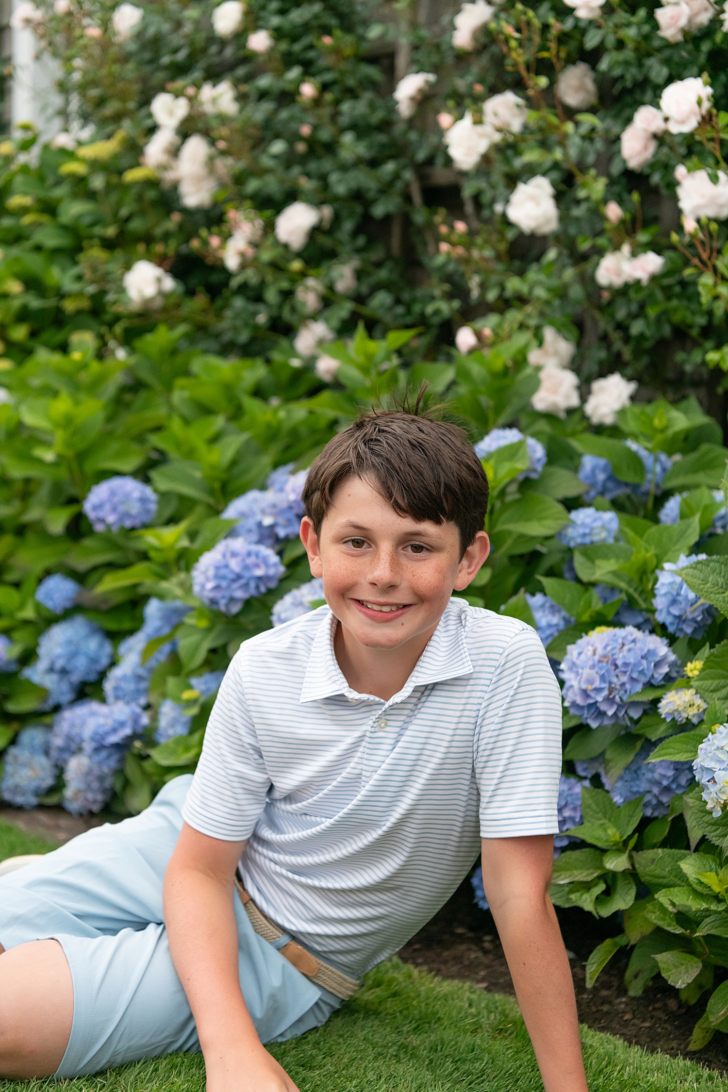 boy with brown hair in front of flowers by Nantucket Family Photographer