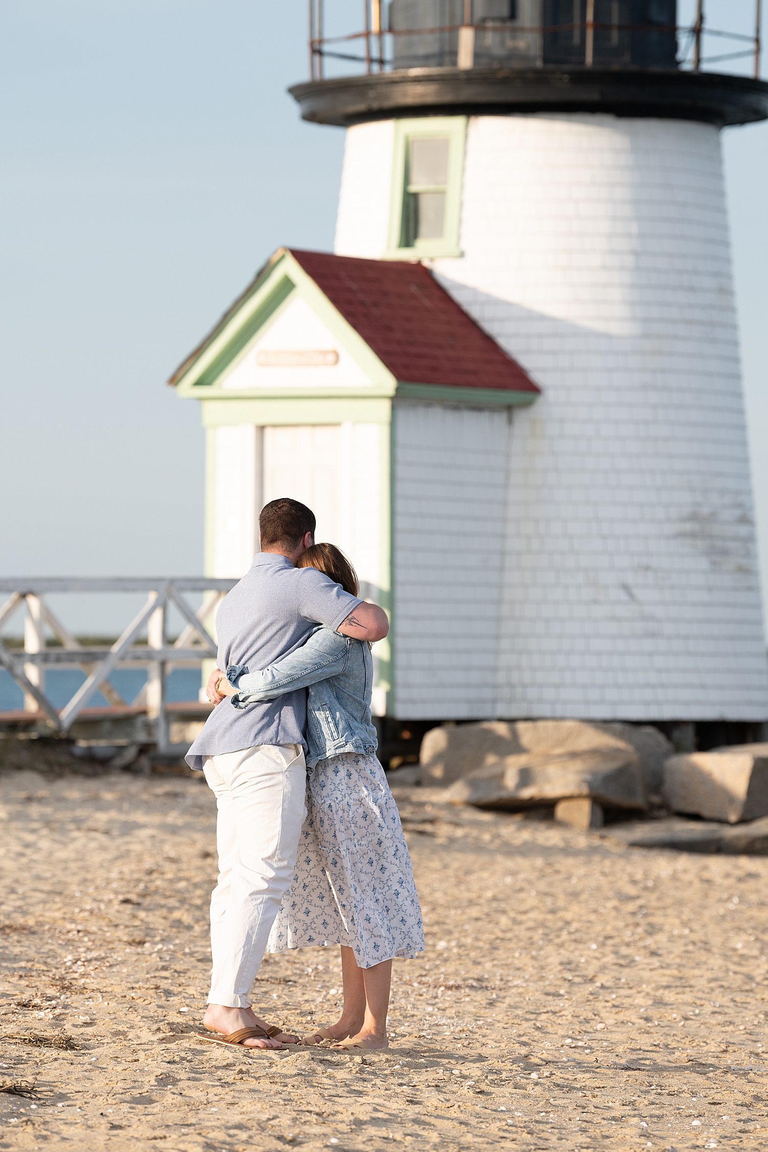 man wraps up his new fiance in a big hug by Nantucket family photographer