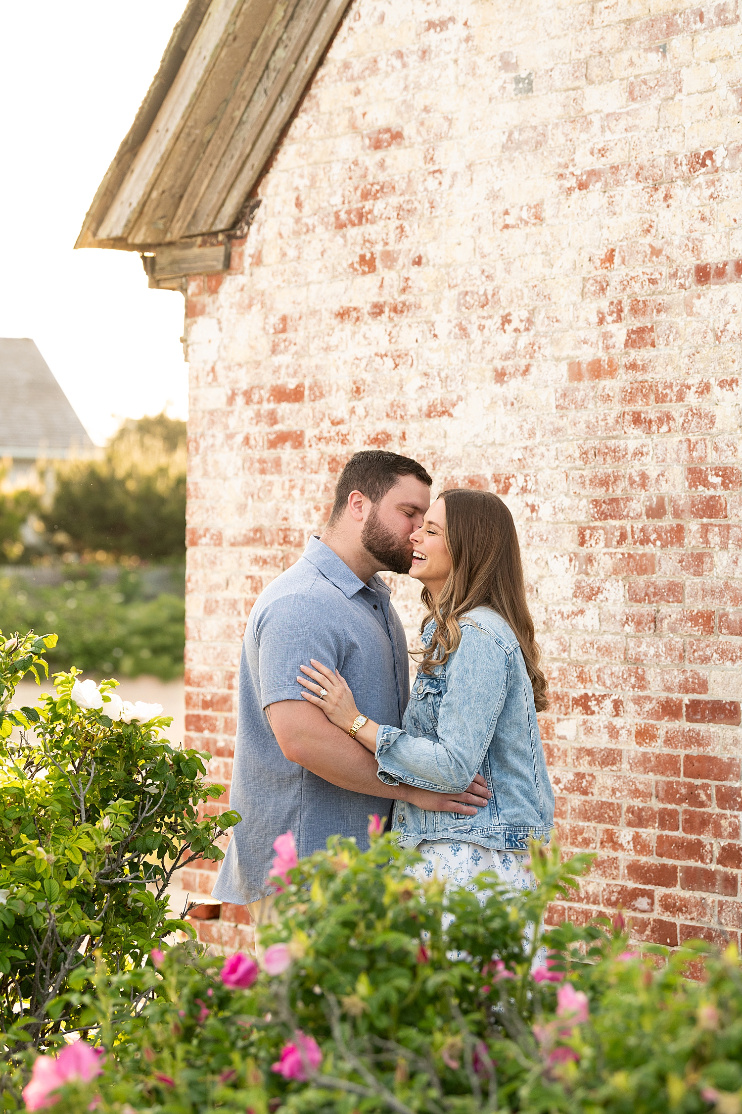 man kisses his new fiance's cheek for Sunset Proposal at Brant Point Lighthouse