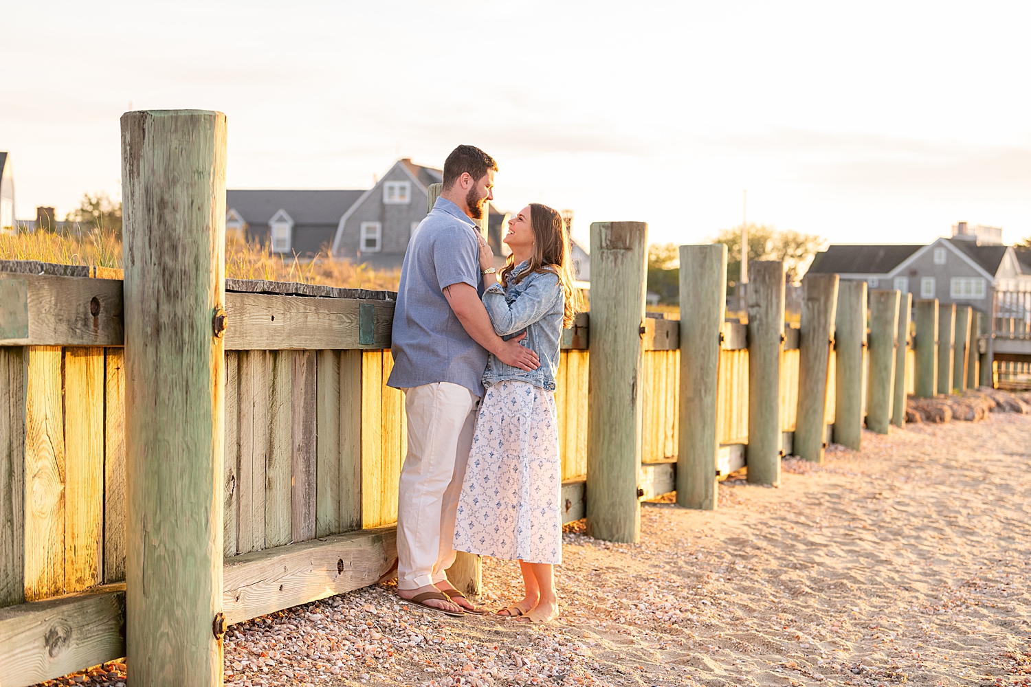 woman snuggles up next to her man at the pier by Rachel Elizabeth Photography