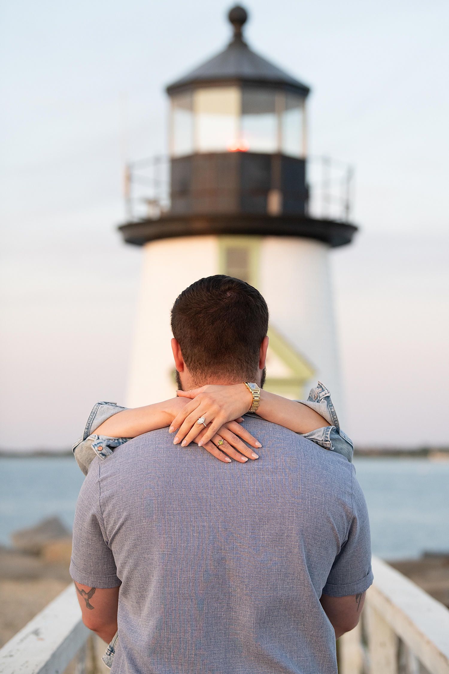 a newly engaged couple embraces and shows off new diamond ring by Rachel Elizabeth Photography