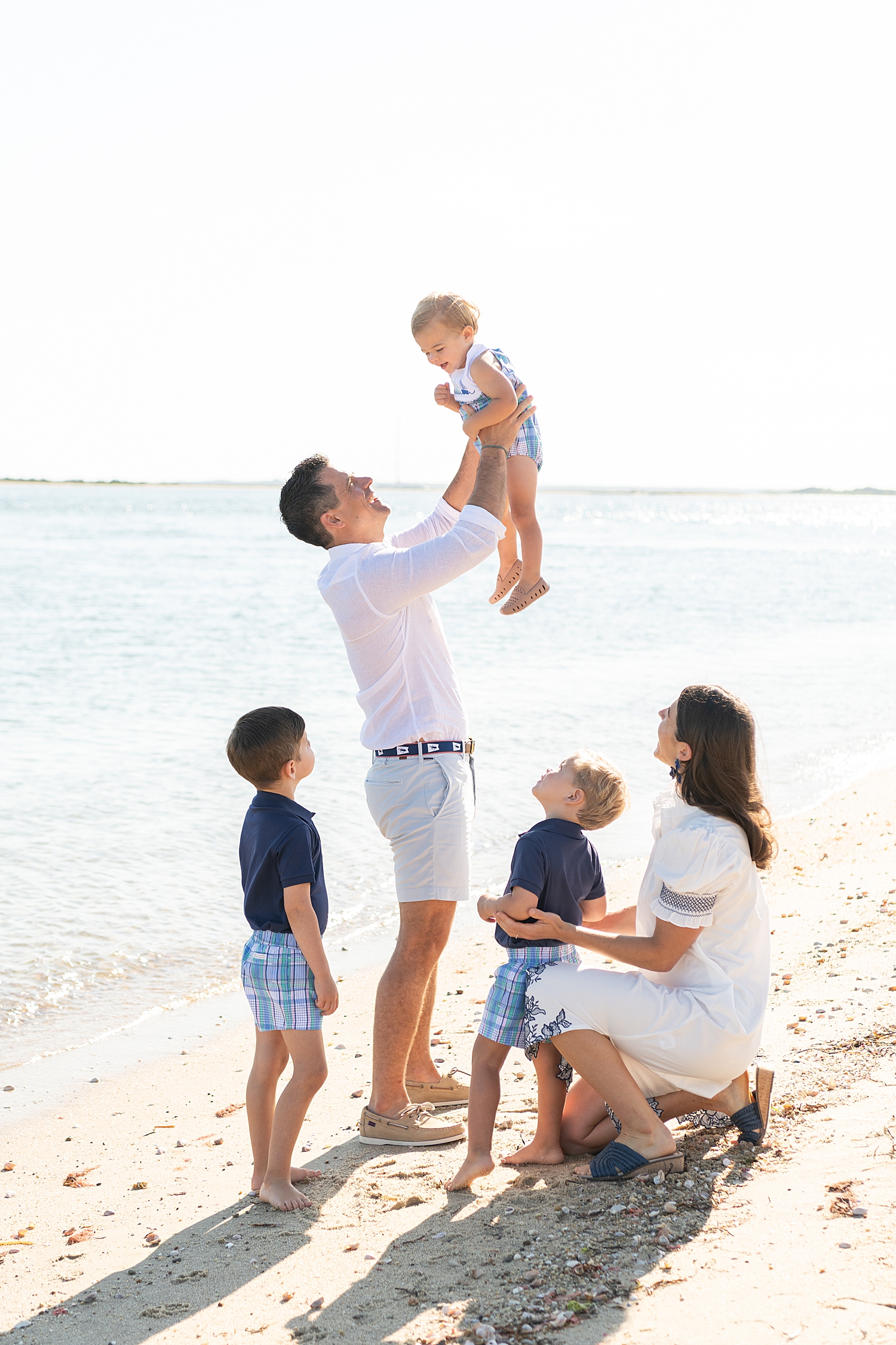 dad lifts up toddler with family nearby after learning what to wear