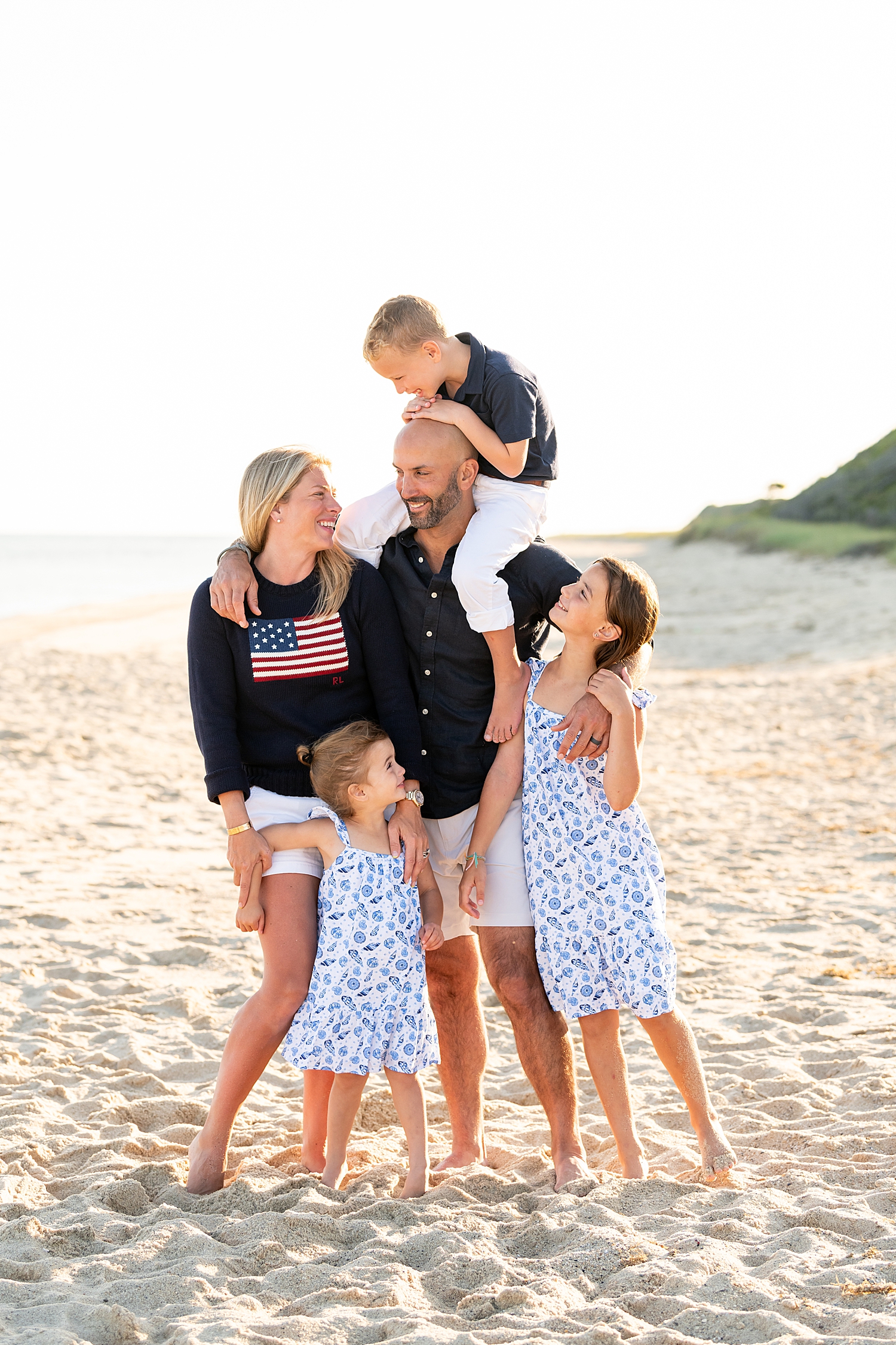 parents in patriotic clothing with kids on sand by Rachel Elizabeth Photography