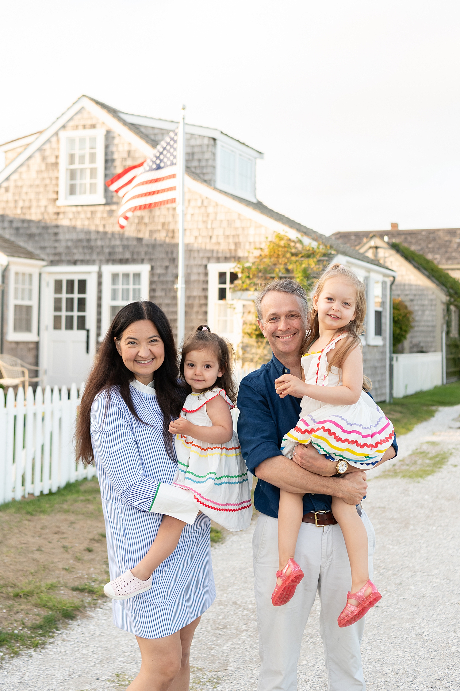two parents with their toddlers in colorful clothing by Rachel Elizabeth Photography