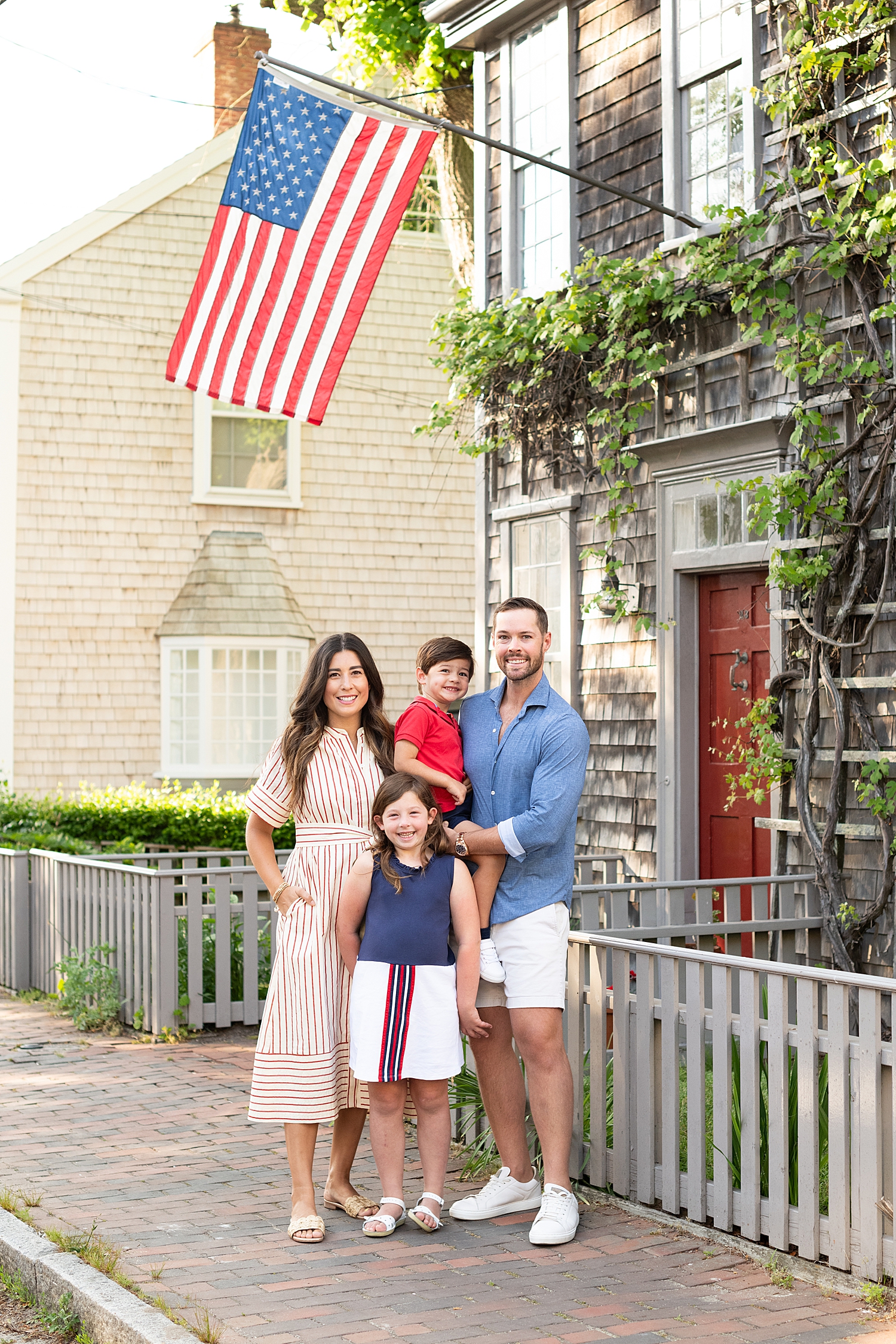 patriotic family of 4 under flag after learning what to wear