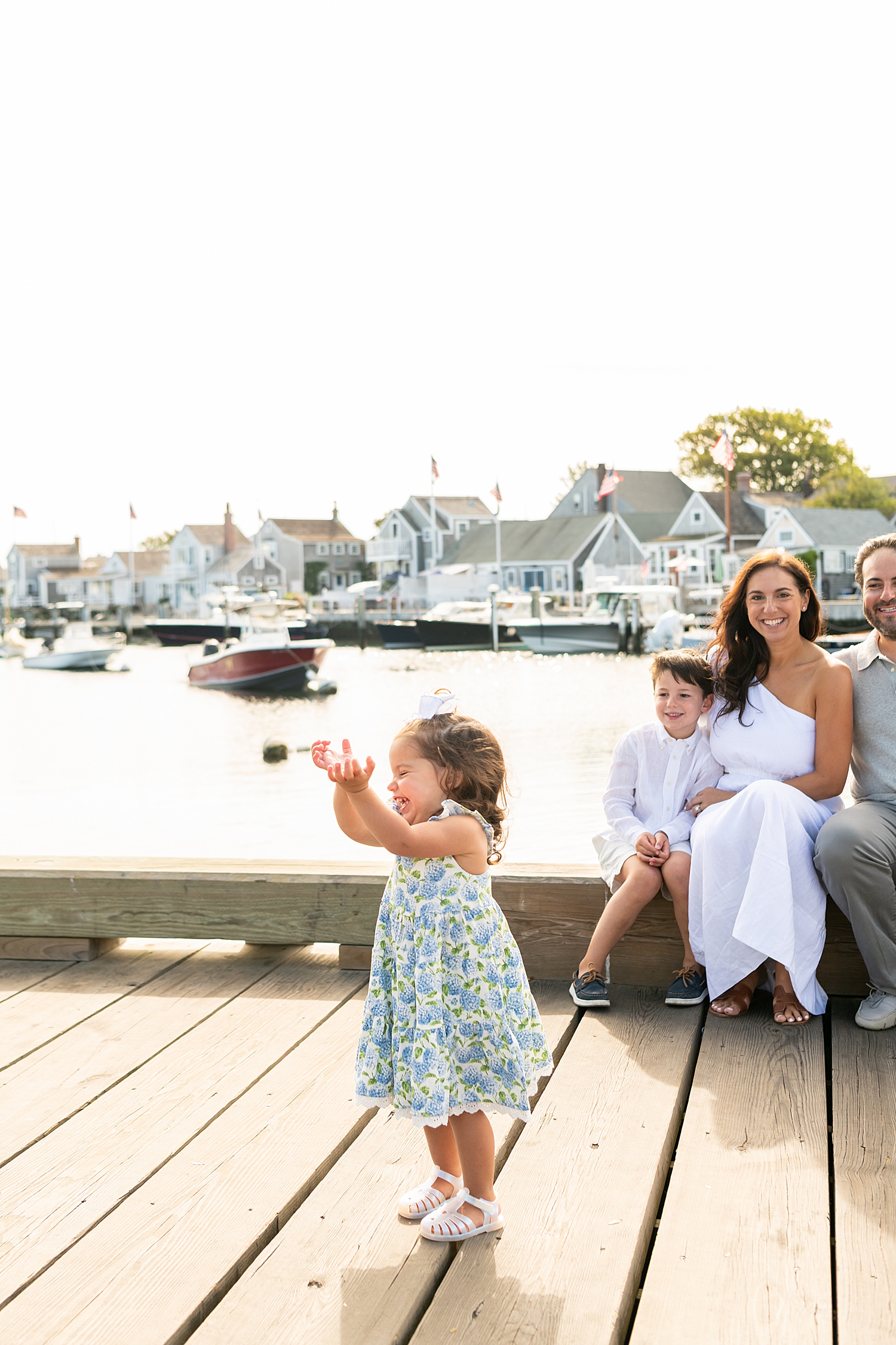 little girl plays on dock in front of water showing how to personalize your session