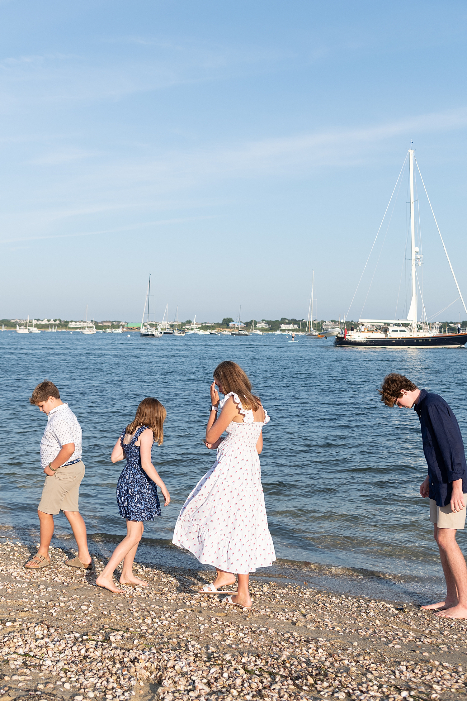four kids look on sand for shells by Rachel Elizabeth photography