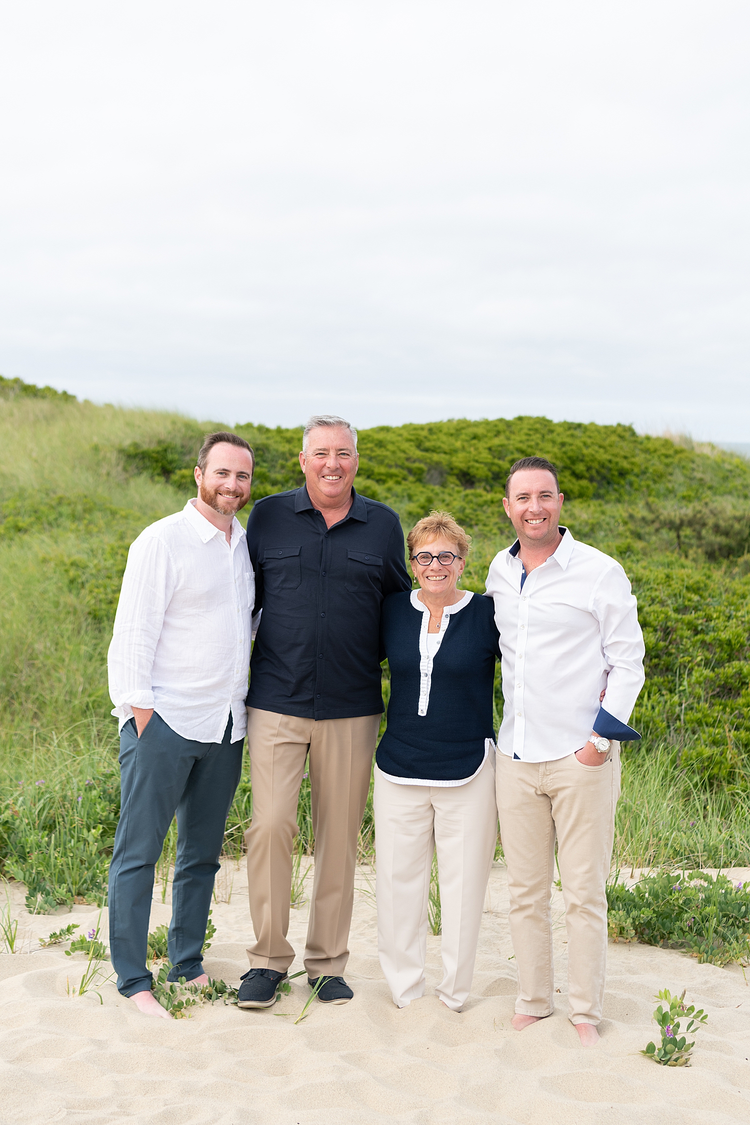 older parents stand with their two sons by Rachel Elizabeth Photography