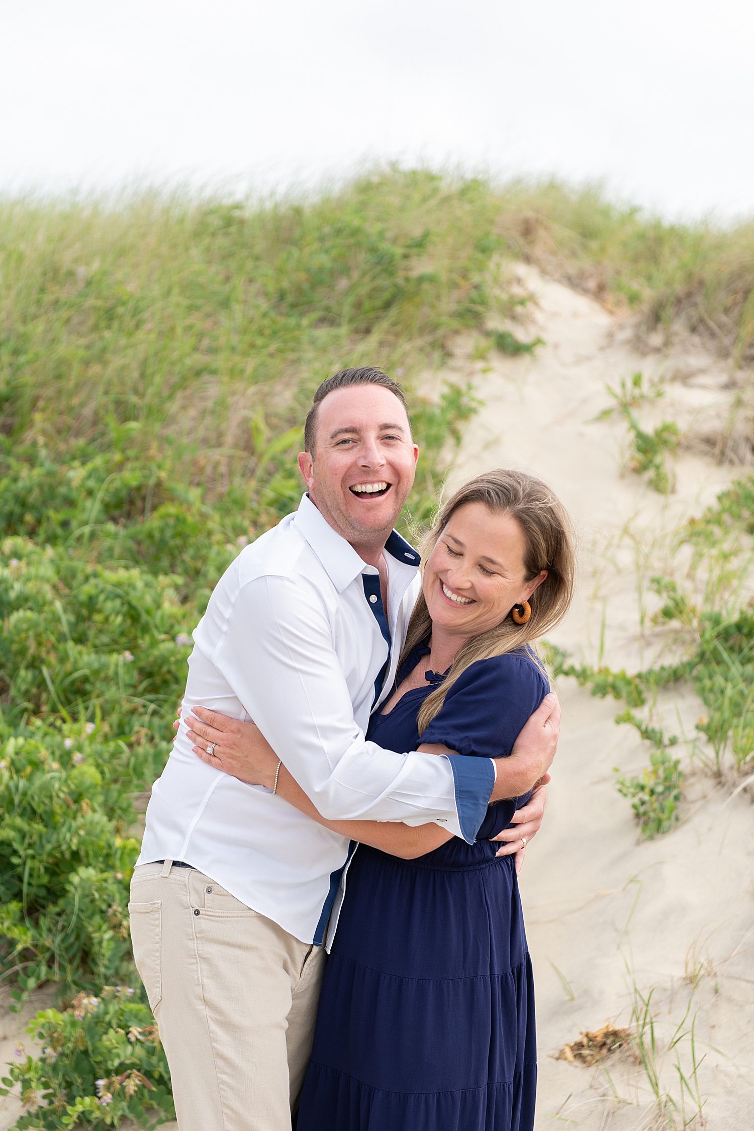 couple laughs together on sand for Summer session at Washing Pond Beach