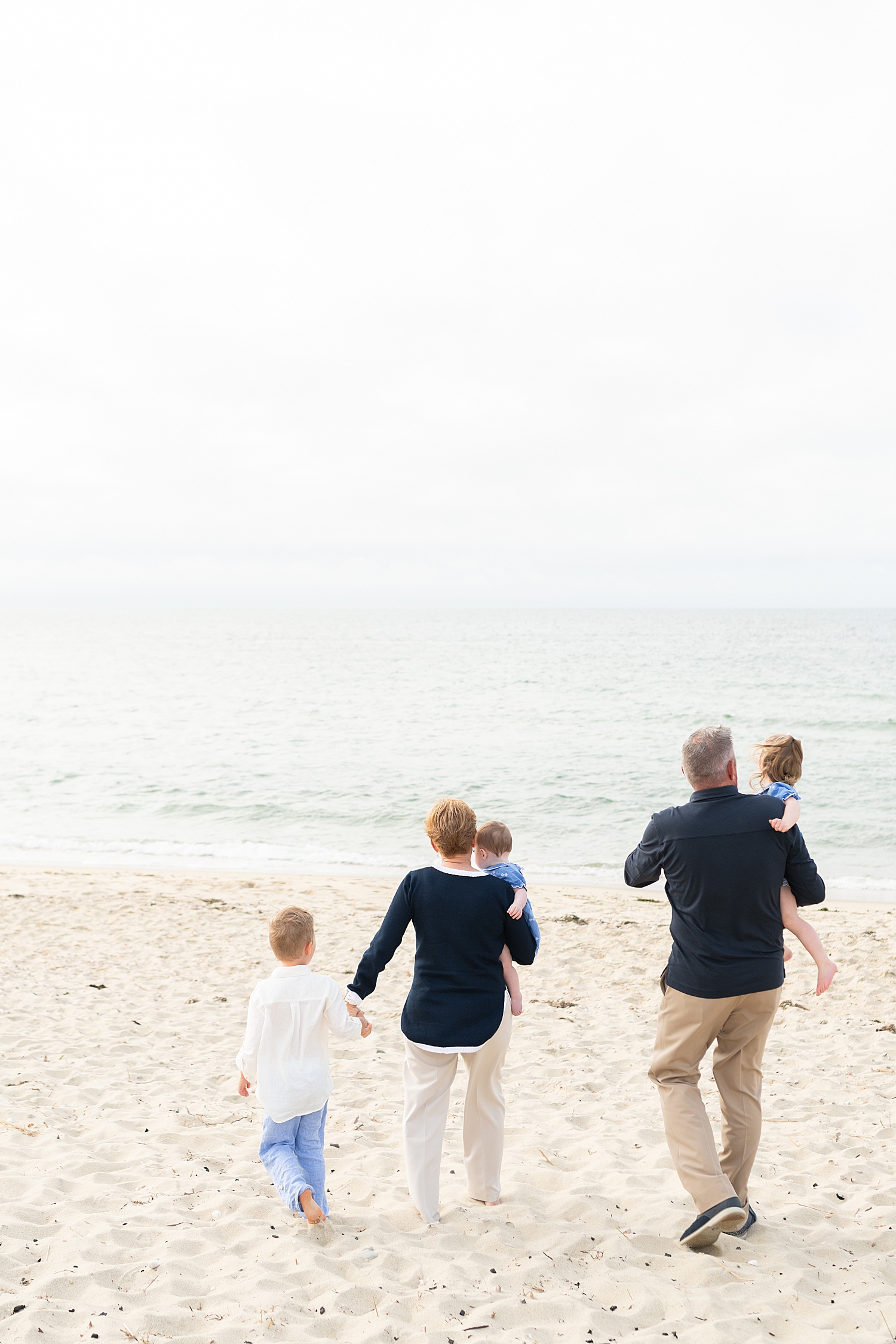 grandparents walk with their grandchildren down to the water by Nantucket Family Photographer