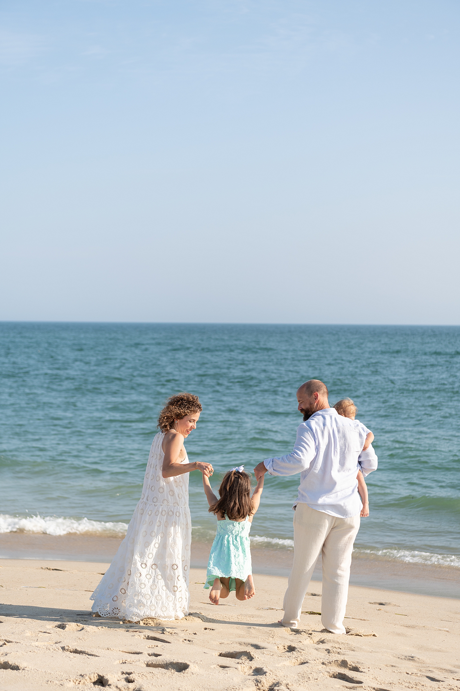 parents play with their kids by the waterfront for Family Session in Madaket