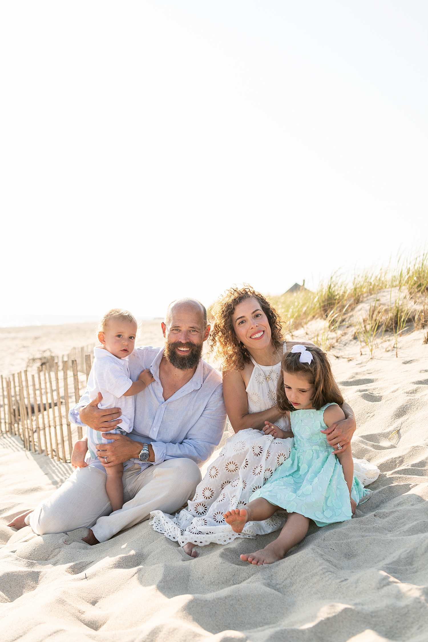 mom and dad sit with their kids for Family Session in Madaket