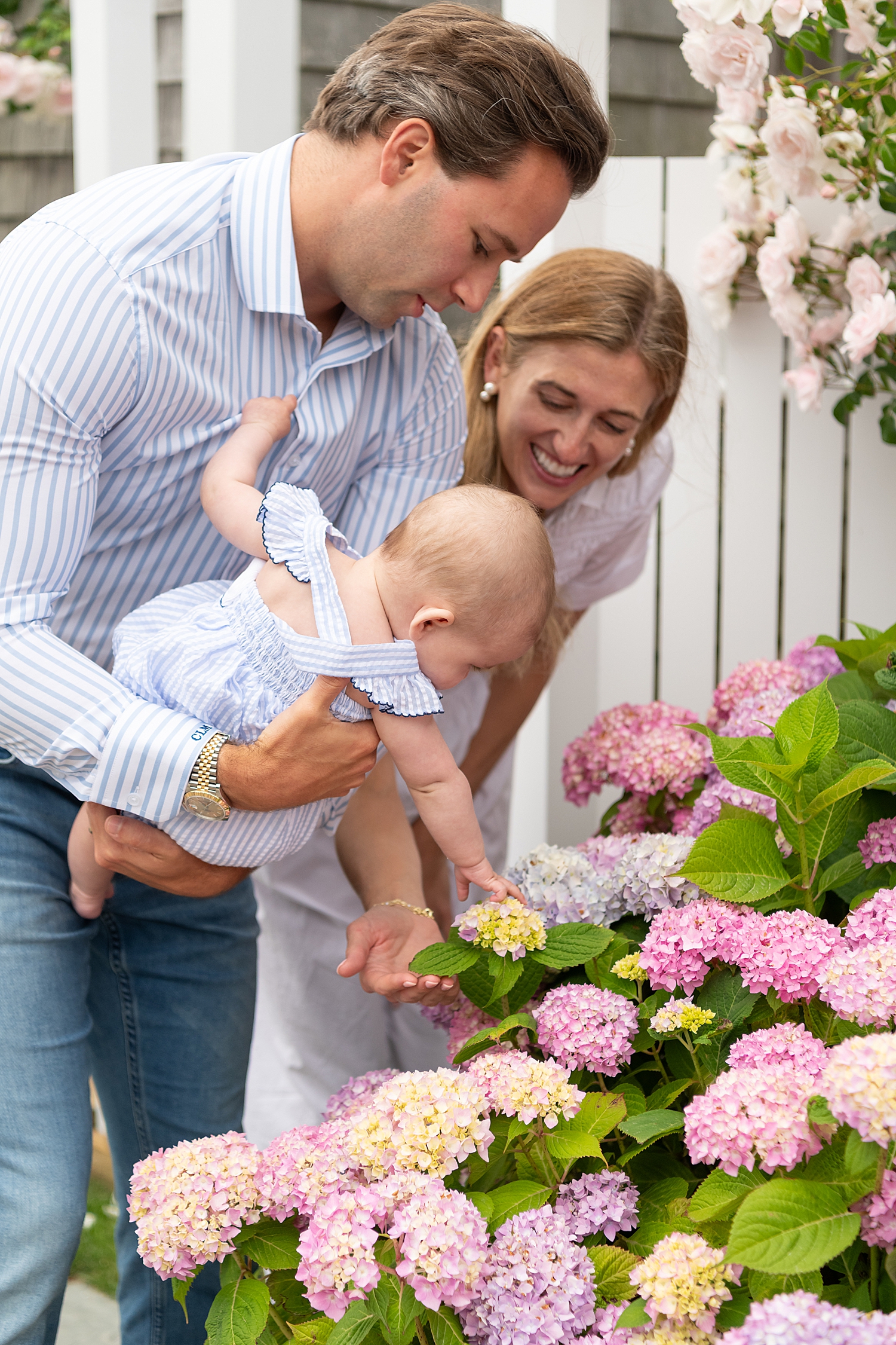 baby reaches for hydrangeas for child-led family photo session