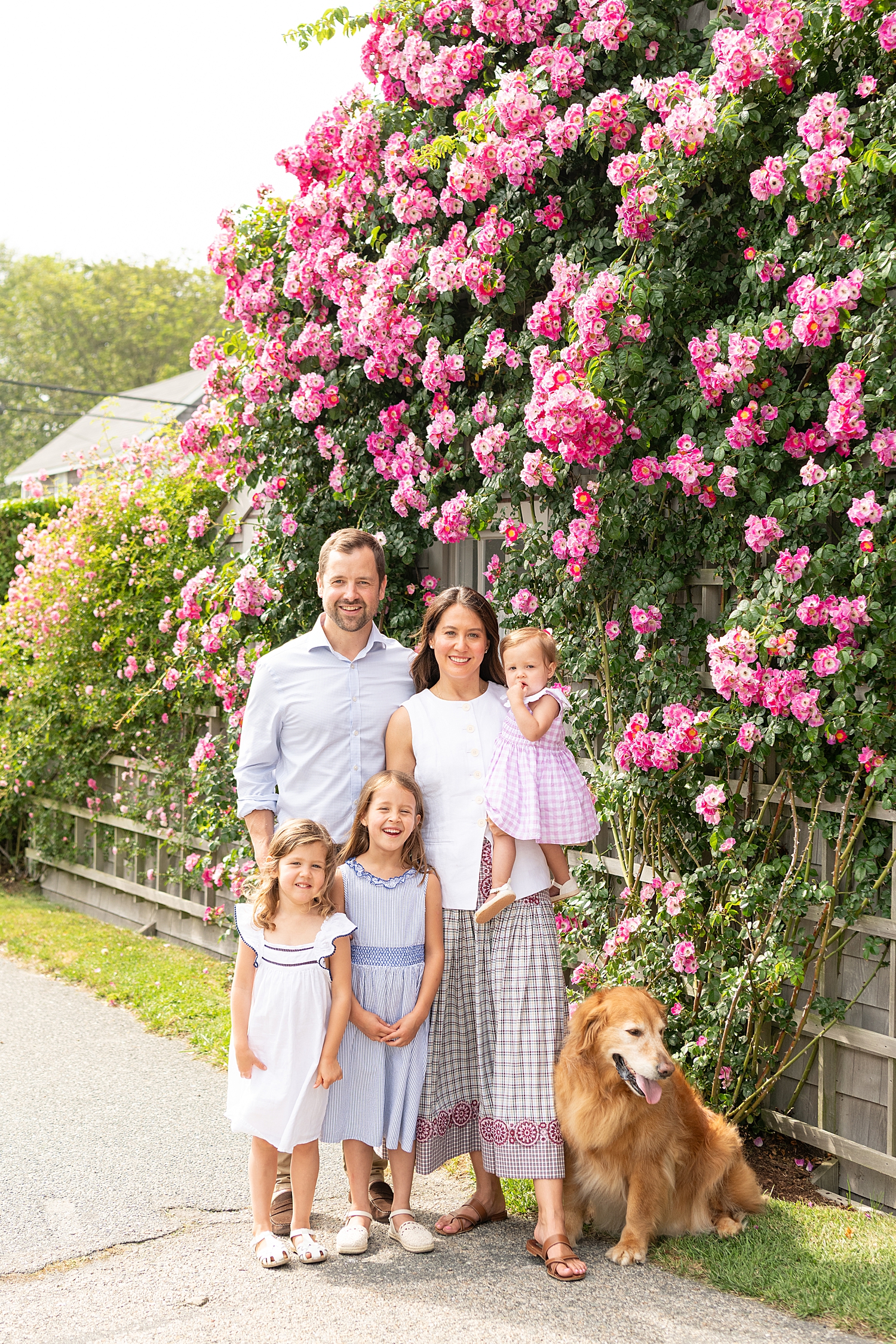 mom and dad stand with three kids and dog under hydrangeas at Sconset Beach